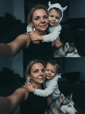 На фотографии, сделанной случайно в стиле жизни, нет никаких знаков постановки. Это реалистичное изображение, зафиксированное на iPhone 17 Pro Max, где отсутствует идеальная симметрия. Кожа выглядит сверкающей, с просвечивающими порами, сохраненная в формате RAW. В интимной обстановке дома модель делает селфи, окруженная мягким рассеянным светом, создающим глубокие, но нежные тени, придающие объем и тепло объятиям. На заднем плане малыш в светло-сером оверсайз худи с объемным капюшоном, украшенным двумя выступающими деталями, напоминающими рожки; он обнимает модель за плечи, его руки нежно, но крепко обхватывают ее. Малыш, улыбаясь, повернут лицом к камере. 